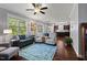 Bright and airy living room with hardwood floors and view into kitchen and dining nook at 1211 Yellow Wood Dr, Mebane, NC 27302