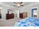 Large main bedroom with carpet flooring, dresser, walk-in closets and tray ceilings at 1211 Yellow Wood Dr, Mebane, NC 27302