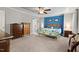 Large primary bedroom boasts carpeted floors, accent wall, and tray ceilings at 1211 Yellow Wood Dr, Mebane, NC 27302