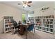 Home office featuring built in bookshelves, window, ceiling fan and a desk with computer setup at 1211 Yellow Wood Dr, Mebane, NC 27302