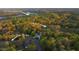 Aerial view of the estate backing up to a lush golf course and serene Little River Reservoir at 1213 Rocky Point Ln, Durham, NC 27712