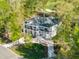 Picturesque aerial view of the home surrounded by lush trees and a golf course, showcasing its serene setting at 1213 Rocky Point Ln, Durham, NC 27712