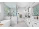 Modern bathroom with a soaking tub, a glass shower, and double vanity with marble countertops at 1213 Rocky Point Ln, Durham, NC 27712