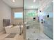 Well-lit bathroom with soaking tub and a glass-enclosed shower with decorative tile at 1213 Rocky Point Ln, Durham, NC 27712