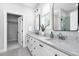 Beautiful bathroom with double vanity, granite countertops, black hardware, and tile flooring at 1213 Rocky Point Ln, Durham, NC 27712