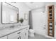 Bright bathroom featuring a tub/shower combination with tile surround, white vanity with black hardware and updated fixtures at 1213 Rocky Point Ln, Durham, NC 27712