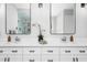 Double vanity with marble countertops, modern sinks, and black framed mirrors in the bathroom at 1213 Rocky Point Ln, Durham, NC 27712