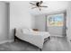 Bedroom featuring a ceiling fan, neutral carpet and a window offering exterior views at 1213 Rocky Point Ln, Durham, NC 27712