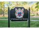 Close up of a McConnell Golf Property sign with detailed crest on a manicured lawn at 1213 Rocky Point Ln, Durham, NC 27712