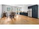 Bright dining area with stainless fridge, a table setting, hardwood floors, and ample storage at 1213 Rocky Point Ln, Durham, NC 27712