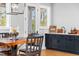 Close-up of the dining area featuring wooden table and chairs, wet bar, and French doors to the porch at 1213 Rocky Point Ln, Durham, NC 27712