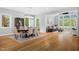 Spacious dining and living area with hardwood floors, modern lighting, and large windows with backyard views at 1213 Rocky Point Ln, Durham, NC 27712