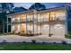 Elegant two-story home featuring spacious porches, three-car garage, and well-maintained landscaping at 1213 Rocky Point Ln, Durham, NC 27712
