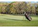 Scenic golf course view with lush green grass, mature trees, and a Callaway golf bag at 1213 Rocky Point Ln, Durham, NC 27712