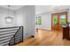 Second-floor hallway featuring hardwood floors and wooden double doors to the outdoor porch at 1213 Rocky Point Ln, Durham, NC 27712
