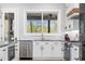 Kitchen features stainless steel appliances, white cabinets, granite countertops, and a view of the backyard at 1213 Rocky Point Ln, Durham, NC 27712