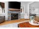Living room showcasing a stone fireplace and an open floor plan leading into the kitchen and dining area at 1213 Rocky Point Ln, Durham, NC 27712