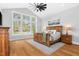 Bright bedroom with hardwood floors, a vaulted ceiling, a large window and a rustic wood bed frame at 1213 Rocky Point Ln, Durham, NC 27712