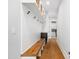 Mudroom with hardwood floors, white wainscoting, bench and access to laundry room at 1213 Rocky Point Ln, Durham, NC 27712