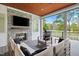 An outdoor patio featuring a stone fireplace, comfortable seating, and views of the backyard at 1213 Rocky Point Ln, Durham, NC 27712