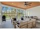 Covered patio with comfortable seating, ceiling fan, outdoor kitchen and golf course views at 1213 Rocky Point Ln, Durham, NC 27712