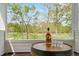 Porch with a bottle of Buffalo Trace on a barrel table overlooking a picturesque golf course at 1213 Rocky Point Ln, Durham, NC 27712