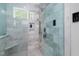 Close up of a large shower with bench, handheld sprayer, and digital controller at 1213 Rocky Point Ln, Durham, NC 27712