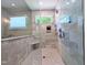 Modern shower with marble style tile, glass door, and a rain style shower head at 1213 Rocky Point Ln, Durham, NC 27712