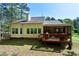 Home exterior featuring a wooden deck, screen porch, and fenced backyard at 1310 Country Club Dr, Durham, NC 27712
