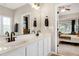 Beautiful bathroom with double sinks, white cabinetry, and modern dark fixtures at 1310 Country Club Dr, Durham, NC 27712