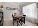 Dining room with seating for four, neutral carpet, and a large window at 1310 Country Club Dr, Durham, NC 27712