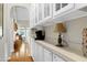 Hallway nook showcasing white cabinetry and countertops with a view of the living room at 1310 Country Club Dr, Durham, NC 27712