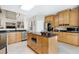 Well-equipped kitchen featuring granite countertops, stainless steel appliances and a kitchen island at 1310 Country Club Dr, Durham, NC 27712