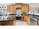 Well-equipped kitchen featuring granite countertops, stainless steel appliances and custom cabinets at 1310 Country Club Dr, Durham, NC 27712