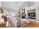 Spacious living room with vaulted ceiling, built-in shelving, fireplace, and hardwood floors at 1310 Country Club Dr, Durham, NC 27712