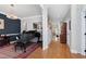 Elegant living room with hardwood floors, piano, and neutral paint colors, great for entertaining at 1310 Country Club Dr, Durham, NC 27712