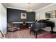 Cozy living room showcasing dark accent wall, a piano, area rug, and chair at 1310 Country Club Dr, Durham, NC 27712