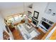 Vaulted living room with hardwood floors, fireplace, and built-in shelving at 1310 Country Club Dr, Durham, NC 27712