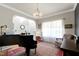 Bright living room featuring a piano, area rug, and comfortable seating with natural light at 1310 Country Club Dr, Durham, NC 27712
