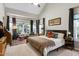 Spacious main bedroom with a high ceiling, large window, and a comfortable sitting area at 1310 Country Club Dr, Durham, NC 27712