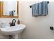 Modern powder room with a pedestal sink, a stylish faucet, and a decorative mirror at 1310 Country Club Dr, Durham, NC 27712