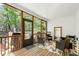 Relaxing screened porch with wooded views features wood flooring, white beadboard ceiling, and comfortable seating at 1310 Country Club Dr, Durham, NC 27712