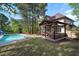 Backyard featuring an in-ground pool, outdoor lounge, and mature trees at 132 Wheatsbury Dr, Cary, NC 27513