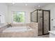 Luxurious bathroom featuring a soaking tub and a separate glass-enclosed shower at 132 Wheatsbury Dr, Cary, NC 27513