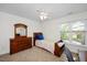 Bright bedroom features a twin bed, dresser with mirror, and a window view at 132 Wheatsbury Dr, Cary, NC 27513