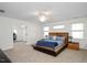 Spacious bedroom with a modern bed frame and access to a separate office space at 132 Wheatsbury Dr, Cary, NC 27513