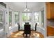 Breakfast nook with backyard views and a glass table with modern chairs at 132 Wheatsbury Dr, Cary, NC 27513