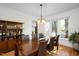 Formal dining room showcasing hardwood floors, a built-in hutch, and backyard views at 132 Wheatsbury Dr, Cary, NC 27513