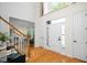 Bright foyer featuring hardwood floors, a staircase, and plenty of natural light at 132 Wheatsbury Dr, Cary, NC 27513