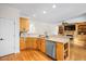 Kitchen with wood cabinets, stainless appliances, and an open design to the living space at 132 Wheatsbury Dr, Cary, NC 27513